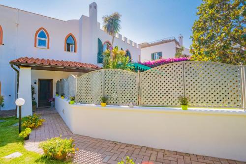 a white fence in front of a house at Villa al Porto in Ischia