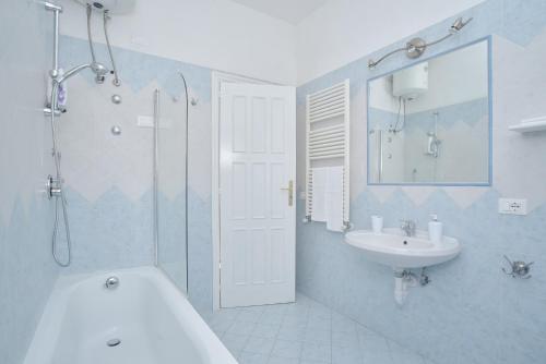 a bathroom with a tub and a sink and a shower at Villa al Porto in Ischia
