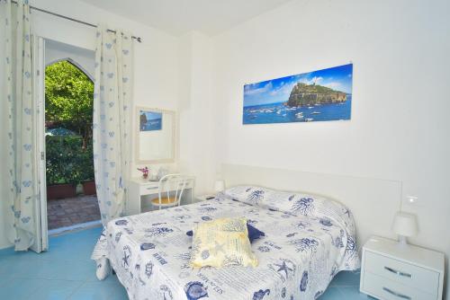 a bedroom with a bed and a window at Villa al Porto in Ischia