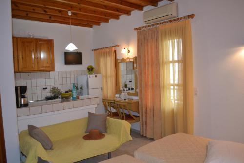 a room with a kitchen and a living room at Studios Flora Manos in Platis Yialos Mykonos
