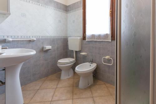 a bathroom with a toilet and a sink at Sul Mare Smith in Lido degli Estensi