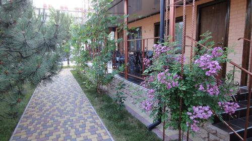 a garden with purple flowers next to a building at Villa Sosnovy Bor in Zatoka