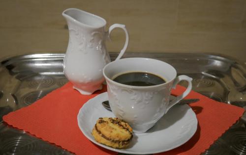 a cup of coffee and a pastry on a table at Noclegi Sebastian w Centrum in Ustrzyki Dolne