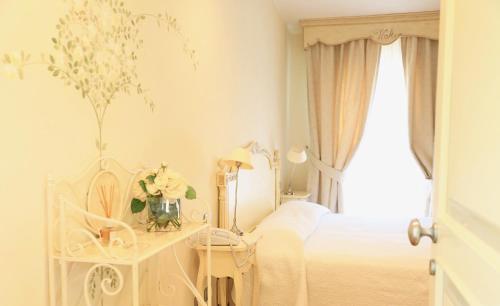 a white bedroom with a bed and a window at Villa Agnese in Sestri Levante