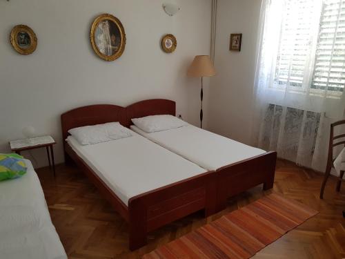 a bed room with two beds in a room at Apartmani Jokić - family only in Pag