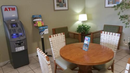 a restaurant with a table and a atm machine at Days Inn by Wyndham Cocoa Cruiseport West At I-95/524 in Cocoa