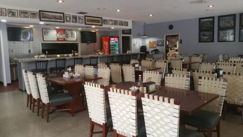 a restaurant with tables and chairs and a bar at Days Inn by Wyndham Cocoa Cruiseport West At I-95/524 in Cocoa