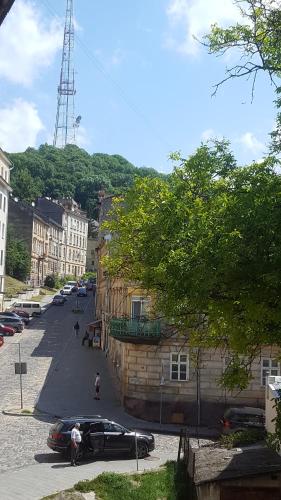 a street with cars parked on the side of a building at Cozy Compact Flat in the City Center in Lviv