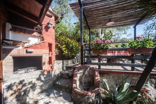 a patio with a fireplace and a statue next to a building at La Fattoria di Nonna Eugenia in Lerici