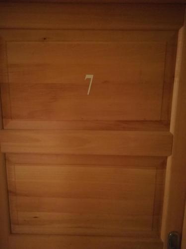 a wooden ceiling with a number on it at Cinema House Single & Double Rooms & Studio Apartments in Pula