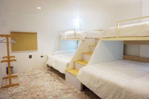 a room with two bunk beds and a chalkboard at Boon Street Hostel in Bangkok