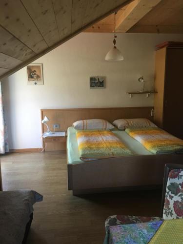 a bedroom with two beds in a room at Weingut Zundlhof in Bolzano