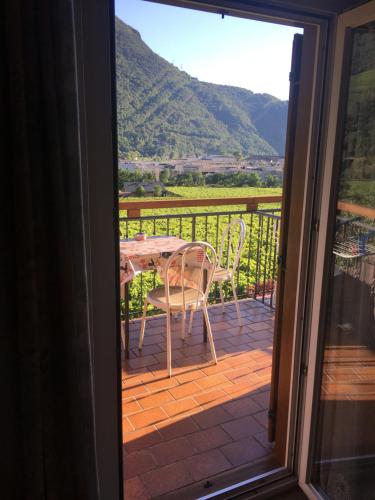 a view from the door of a balcony with a table and chairs at Weingut Zundlhof in Bolzano