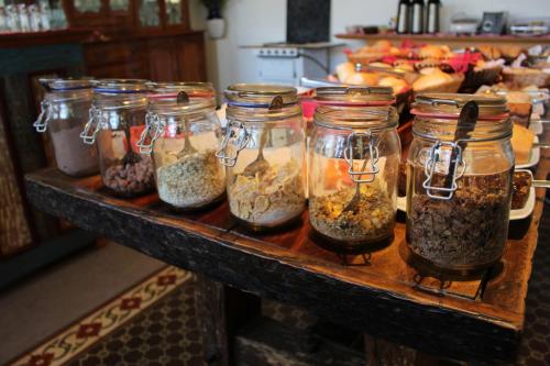 a table with jars filled with nuts and seeds at Pousada Chão de Minas Ouro Preto in Ouro Preto
