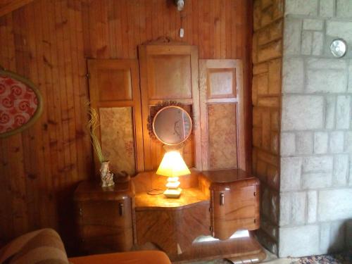 a table with a mirror and a lamp on it at Holiday Home Nature Neno in Visoko