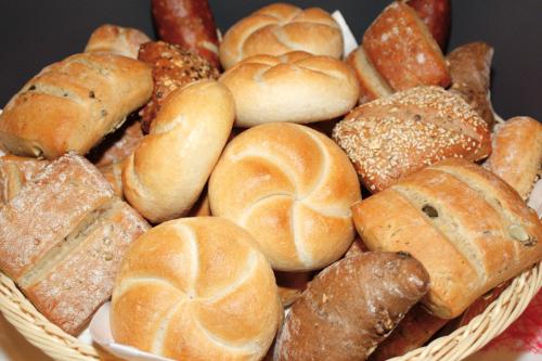 a basket filled with lots of different types of bread at Hotel Europa Guest House in Saas-Fee