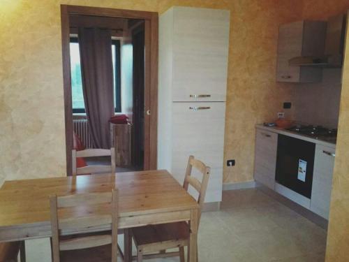 a kitchen and dining room with a wooden table at La Casa di Ninna Affittacamere in Ariano Irpino