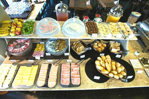 un buffet avec de nombreux types de nourriture sur une table dans l'établissement Gallant Hotel, à Rio de Janeiro