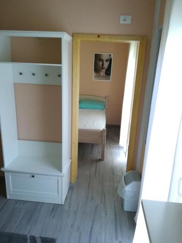 a small bedroom with a bed and a dresser at Cinema House Single & Double Rooms & Studio Apartments in Pula