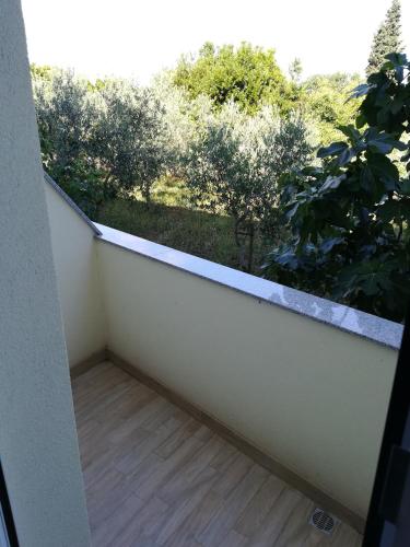 a balcony with a view of a garden at Cinema House Single & Double Rooms & Studio Apartments in Pula