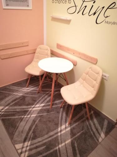 two chairs and a table in a waiting room at Cinema House Single & Double Rooms & Studio Apartments in Pula