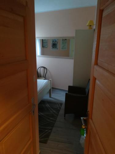 a room with a bedroom with a bed and a chair at Cinema House Single & Double Rooms & Studio Apartments in Pula