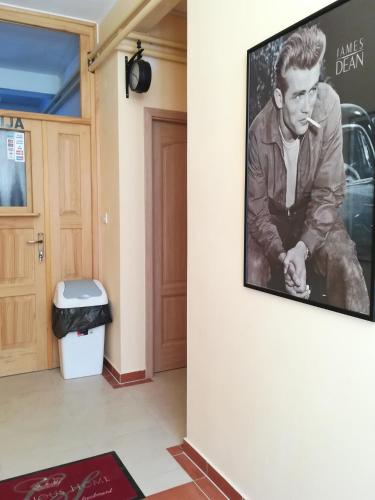 a picture of a man on a wall next to a door at Cinema House Single & Double Rooms & Studio Apartments in Pula