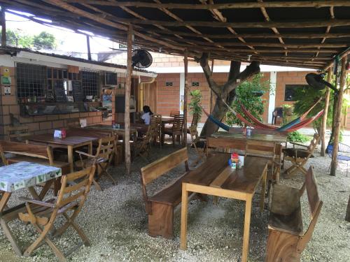 a group of tables and chairs in a restaurant at Hotel Pizzeria Opera Tolú in Tolú