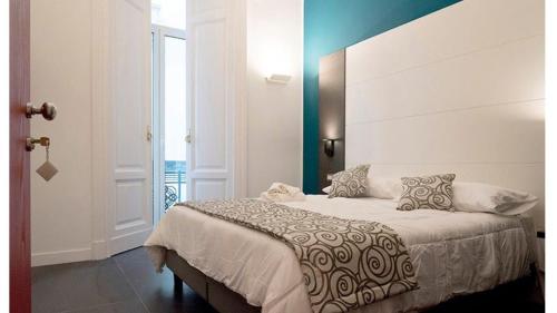 a bedroom with a large bed in a room at FALERON Santa Lucia in Naples