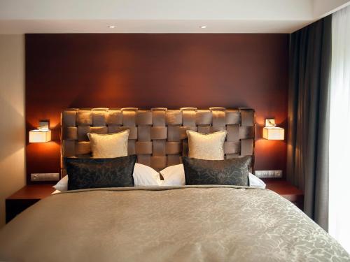 a bedroom with a large bed with two pillows at Hotel Singer in Ludvíkov