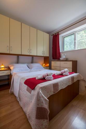 a bedroom with a bed with two towels on it at Apartments Lena in Komiža