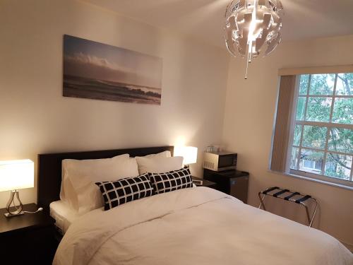 a bedroom with a bed and two lamps and a chandelier at Sawgrass in Sunrise