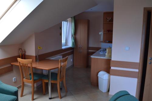 a kitchen and dining room with a table and chairs at Apartmany Svaty Kriz in Liptovský Mikuláš