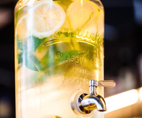 a close up of a bottle with a lemon in it at One Suite Hotel in Mlini