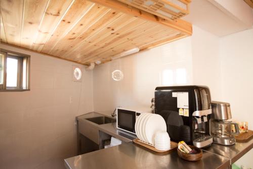 a kitchen with a counter top with a coffee maker at Bukchonae in Seoul