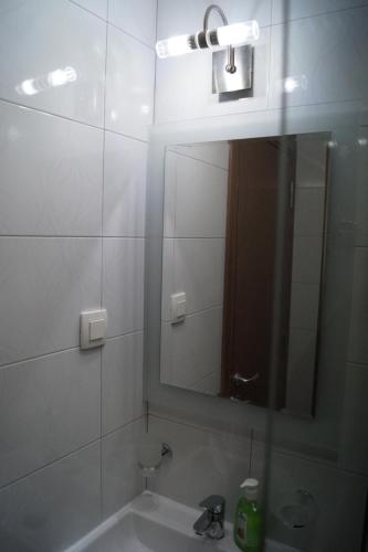 a bathroom with a sink and a mirror at Snegar Apartments in Ohrid