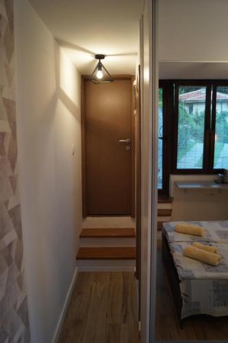 a room with a door and a bed and a window at Snegar Apartments in Ohrid