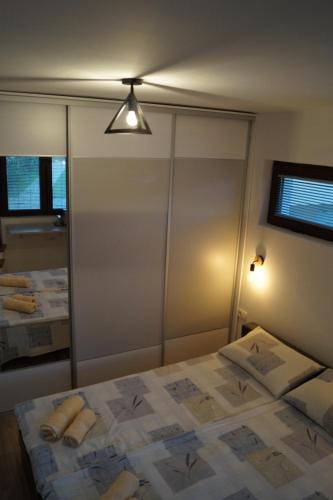 a bedroom with a bed with a large mirror at Snegar Apartments in Ohrid