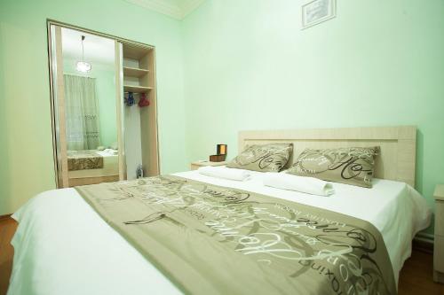 a bedroom with a large bed with white sheets at Apartment in Old Tbilisi Orbeliani Square in Tbilisi City