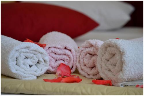 a pile of towels sitting on top of a bed at Apartmani Biočić in Split