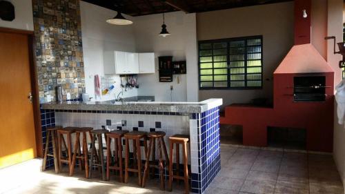 a kitchen with a bar with stools in it at Sitio Sao Jorge in São José da Barra