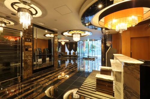 a lobby with chandeliers and a hair salon at APA Hotel Nagoya Sakae Higashi in Nagoya