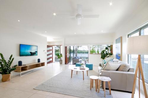 a living room with a couch and a table at Tranquil & Modern Riverside Getaway in Noosaville