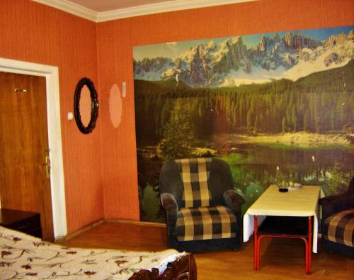 a bedroom with a large painting on the wall at Hotel Lilo near Airport in Tbilisi City