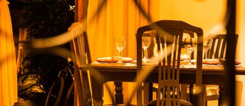 a table with glasses of wine and a chair at Porto dos Casais Guest House Itacaré in Itacaré