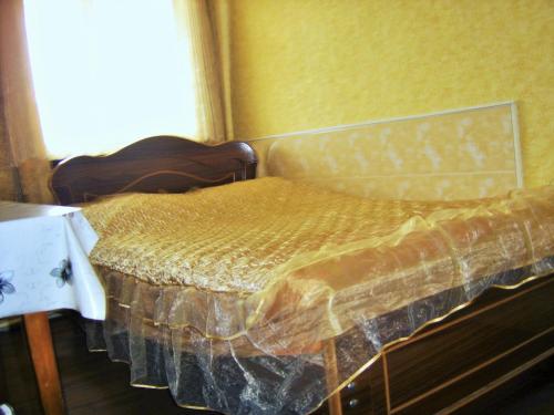 a bed sitting in a room with a window at Hotel Lilo near Airport in Tbilisi City