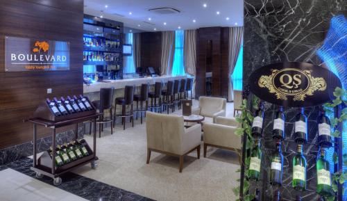 a bar with a bunch of bottles of wine at Qafqaz Baku City Hotel & Residences in Baku