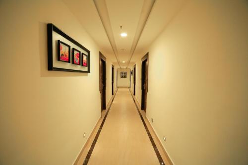 a long hallway with a long aisle in a building at Hotel Apple Ttree in Tirunelveli
