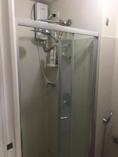 a shower in a bathroom with a glass shower stall at Tagaytay Cool Spot in Tagaytay