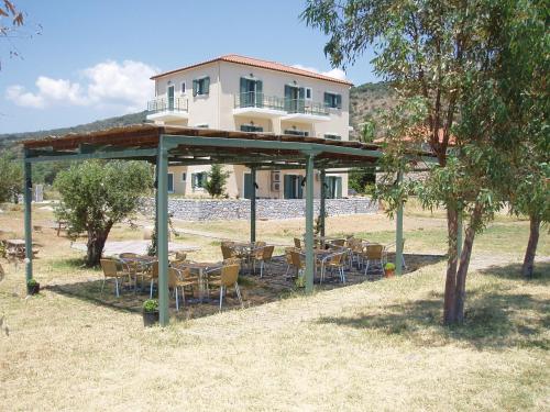 a group of tables and chairs in front of a building at Akti Kamares in Kamáres